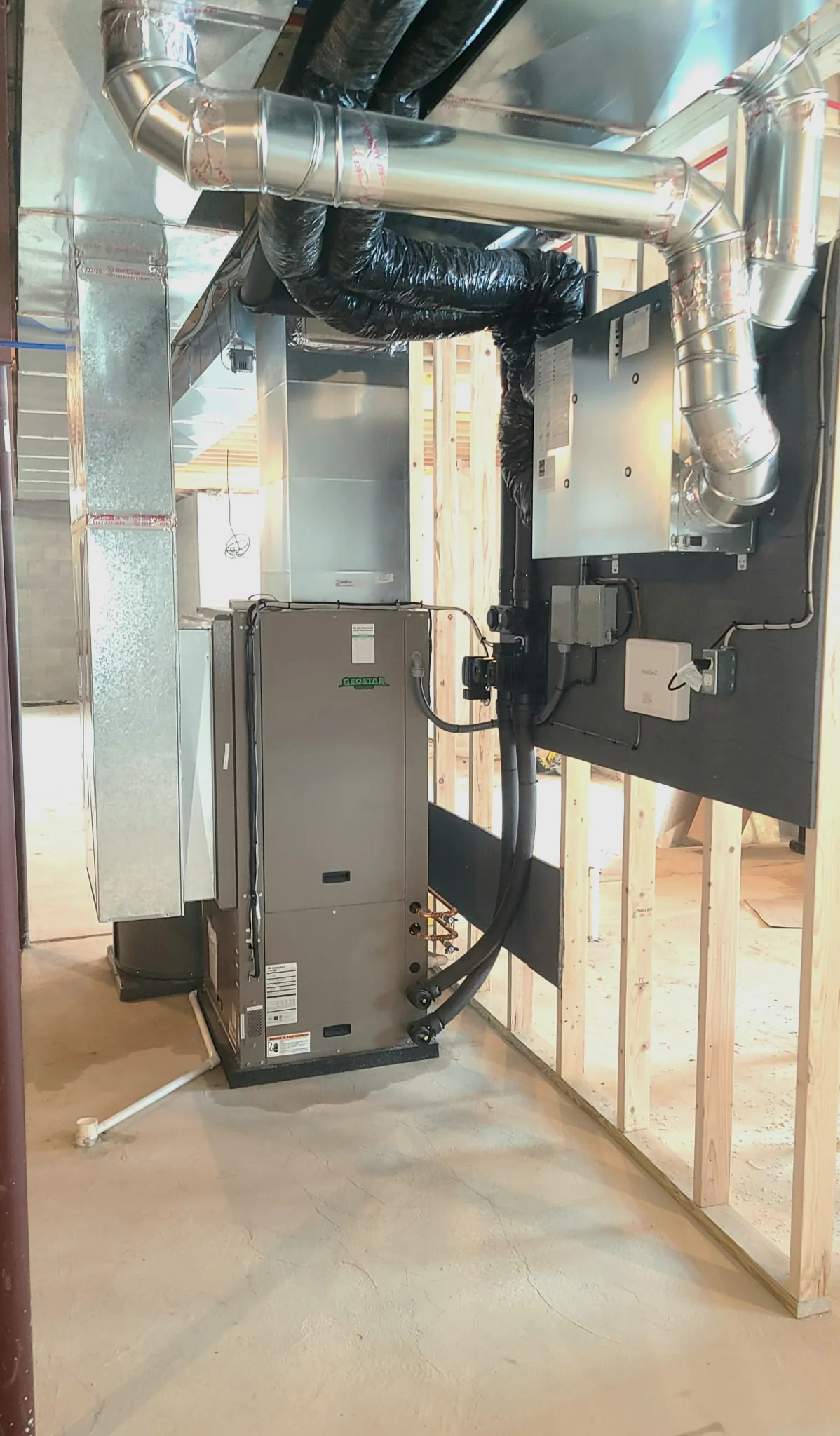 GeoStar geothermal forced-air heat pump with sheet-metal ductwork connecting to home air distribution — 4th Gen Mechanical install.