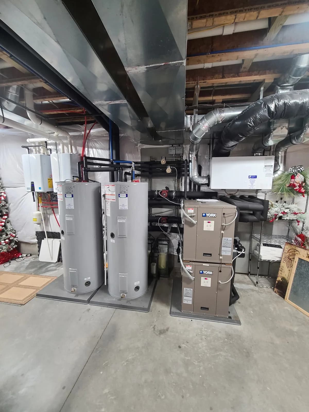 York HVAC system in a basement mechanical room with water heaters and integrated piping — 4th Gen Mechanical install.